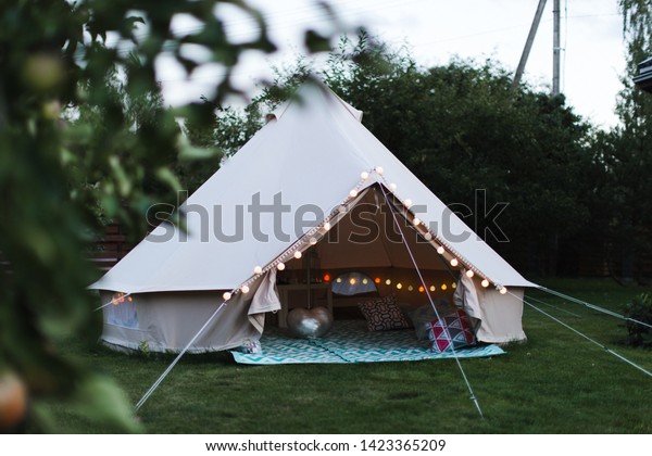Canvas cotton Bell tent in the yard decorated for\
summer kids party