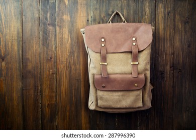 Canvas And Leather Backpack On Wood