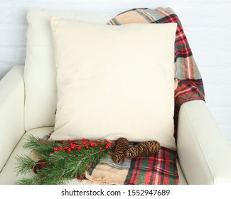 Canvas Pillow square pillow mockup on white leather chair with Christmas props and white brick background - Powered by Shutterstock