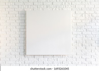 Canvas Poster In Vintage Loft Interior, Background With Pace For Text, Template Design. Empty Picture On White Old Brick Wall. Mock Up Template For Adding Your Content.