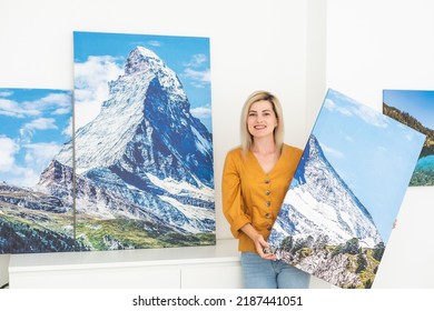 Canvas Print With Gallery Wrap Interior Decor. Woman Hangs Landscape Photography On White Wall. Hands Holding Photo Canvas Print