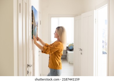 Canvas Print With Gallery Wrap. Woman Hangs Photography On White Wall. Hands Holding Photo Canvas Print