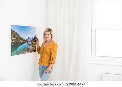 Canvas Print With Gallery Wrap. Woman Hangs Photography On White Wall. Hands Holding Photo Canvas Print