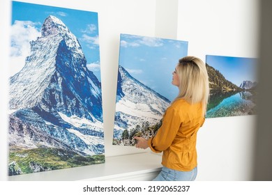 Canvas Print With Gallery Wrap. Woman Hangs Photography On White Wall. Hands Holding Photo Canvas Print