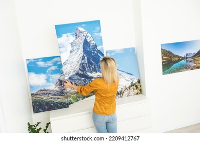 Canvas Print With Gallery Wrap. Woman Hangs Photography On White Wall. Hands Holding Photo Canvas Print