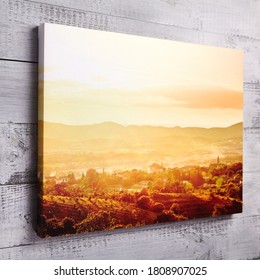 Canvas print hanging on gray wooden wall. Stretched canvas, gallery wrap. Summer sunset pic, landscape photography. Photo printed on canvas, perspective view