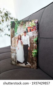 Canvas Print Stretched On Frame With Gallery Wrap, Wedding Photography On Gray Sofa, Photo Printed On Canvas In White Wall Room With Houseplant