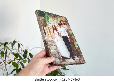 Canvas Print Stretched On Stretcher Bar With Gallery Wrap, Hand Holds Wedding Photography, Photo Printed On Canvas In White Wall Room