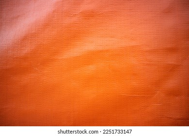 canvas tarpaulin texture, colored orange in the photo on a sunny day - Powered by Shutterstock