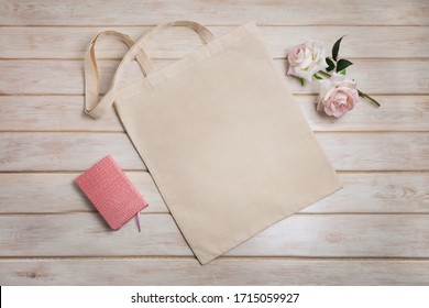 Canvas Tote Bag Mockup With Pink Notepad And Two Roses. Empty Tote Bag Mock Up For Branding Presentation. 