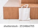 Canvas tote bag on the bench in the park mockup. Rustic linen shopper bag mock up for branding presentation