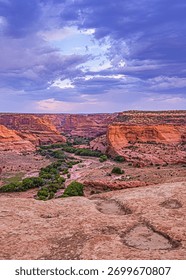 Canyon de Chelly's dramatic sky provides a stunning backdrop to the canyon's landscape. 