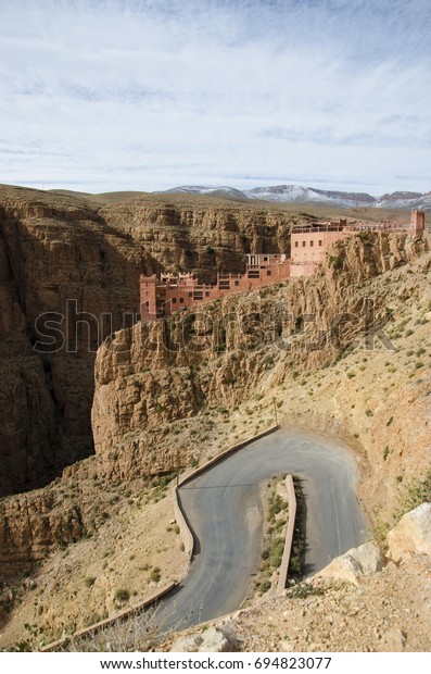 Canyon in Morocco\
with windy road and blue\
sky