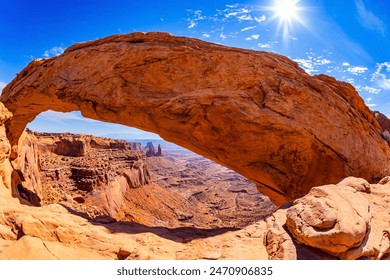 Canyonlands National Park in Utah, USA. The natural Mesa Arch is composed of red-brown sandstones. Hot sunny day. Magnificent trip - Powered by Shutterstock