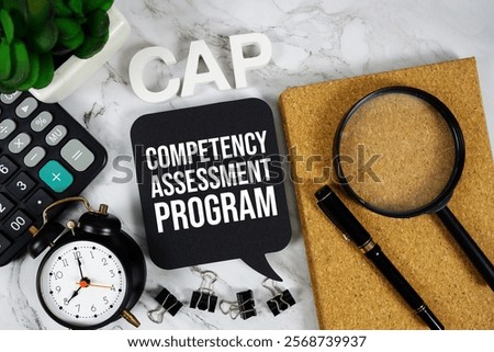 CAP - Competency Assessment Program acronym with calculator, alarm clock and magnifying glass, business concept background