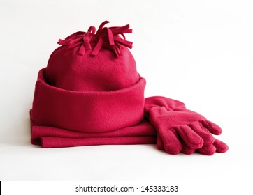 Cap, scarf and gloves purple on a white background