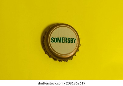 Cap of Somersby cider original. Top view of metal beer cap. Somersby Cider is a brand produced by the Danish beer company Carlsberg Group. Aalborg, Denmark, November 27, 2021