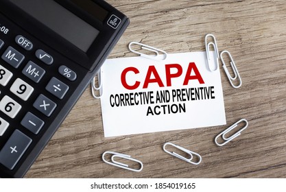CAPA. Corrective and Preventive action. Business and finance concept, text on white paper on wood background