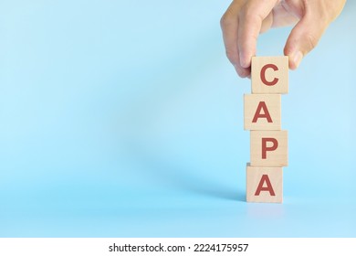 CAPA or corrective and preventive action on wooden blocks in blue background. - Shutterstock ID 2224175957