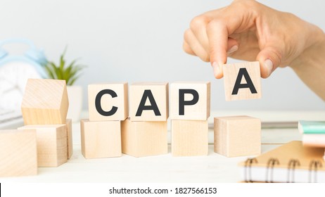 CAPA Corrective and Preventive action plans lettering on wooden cubes