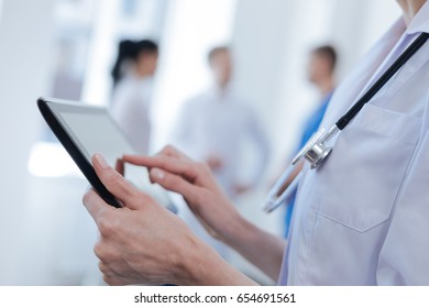 Capable medic using digital gadget at the clinic