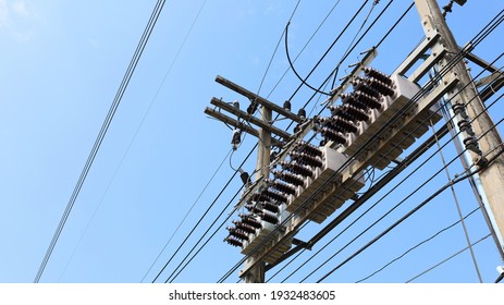 Capacitor Bank On The Pole. A Device For Optimizing Voltage Regulation On Power Transmission Lines And Reducing Voltage Losses On A Blue Sky Background With Copy Space. Selective Focus