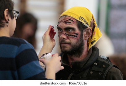 Capdepera Mallorca, Spain. February 24, 2018. A Make Up Artist Apply Ink Over An Actor Before A Zombie Survival Massive Real Role Play Game In The Spanish Island Of Mallorca. 