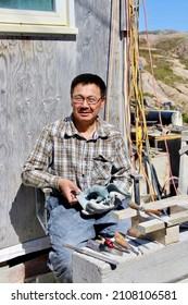 Cape Dorset, Canada - July 2015 A Sculptor Shows His Soapstone Work.