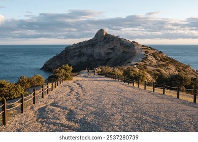 Cape Kapchik Crimean Peninsula, rocky beach with a long road leading to a cliff. The road is lined with wooden posts and ropes, the sky is cloudy. - Powered by Shutterstock