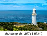 Cape Otway Light Station’s iconic lighthouse stands tall amidst breathtaking ocean views and lush greenery. A historic beacon of maritime navigation, it embodies timeless charm and scenic beauty.