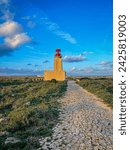 Cape Sagres, lighthouse, ocean, southwest, Europe, Portugal, Algarve. Rocks, rocky shore, yellow rocks, coquina, beautiful coastline