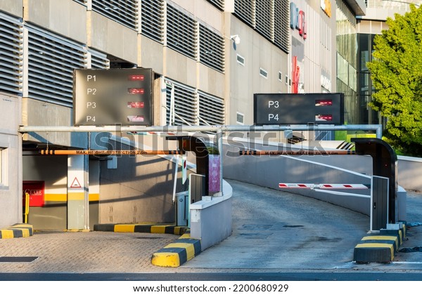 Cape Town - May 04, 2020:  entrance\
driveway ramp up to a multi-storey car park or parking garage in a\
building with no car and deliberate focus on the\
entrance
