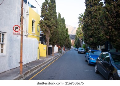 Cape Town, South Africa 18-06-2022

Quiet Street Near Bayview Terrace During Sunset. Colorful Buildings And Road In Foreground.