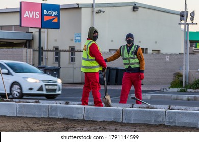 Cape Town, South Africa - August 2020: South African Construction Workers Laying New Road Down. Protective Masks For Corona Virus Pandemic, Covid 19. PPE. City Workers.