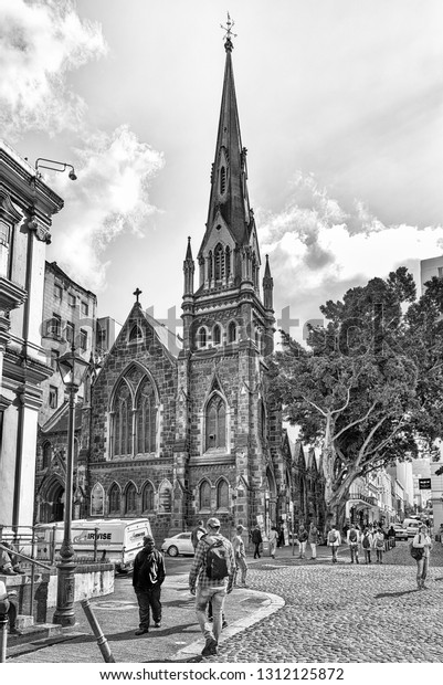 CAPE\
TOWN, SOUTH AFRICA, AUGUST 17, 2018: A view of Greenmarket Square\
in Cape Town in the Western Cape Province. The Central Methodist\
Mission Church and people are visible.\
Monochrome
