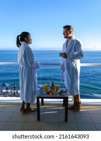 Cape Town South Africa Couple Man And Women Drinking Coffee During On Balcony Sunrise At Vacation In Cape Town South Africa. European Men And Asian Women Waking Up With Coffee Looking Out Over The