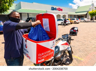 Cape Town, South Africa - December 10, 2020: Express Service Home Delivery Man With Bike Outside Local Pick N Pay Grocery Store