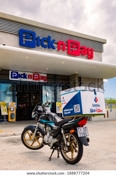 Cape Town, South Africa - December 10, 2020:\
Express Service home delivery bikes parked outside local Pick n Pay\
grocery store