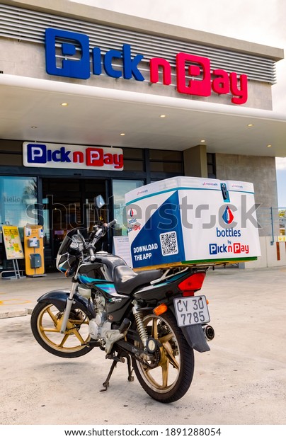Cape Town, South Africa - December 10, 2020:\
Express Service home delivery bikes parked outside local Pick n Pay\
grocery store