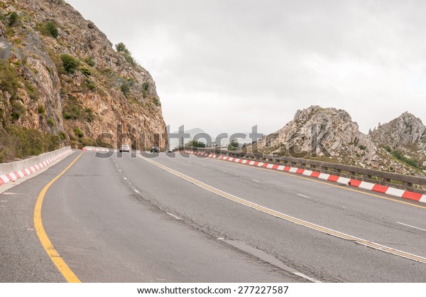 CAPE TOWN,
SOUTH AFRICA - DECEMBER 20, 2014: Top of Sir Lowreys Pass in the
Hottentots-Holland mountains near Somerset West. Safety nets to
keep rockfalls away from the road are
visible