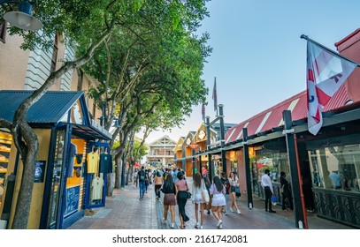 CAPE TOWN, SOUTH AFRICA - February 11, 2022: A View From A Busy Street At The Center Of Waterfront Area With Many People Walking By Shops And Restaurants.