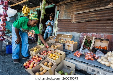 CAPE TOWN, SOUTH AFRICA - FEBRUARY 01: A Local Township Man Sorts Fruit At His Food Stall, In Cape Town, South Africa On February 01, 2012