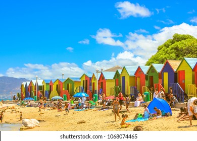 Cape Town, South Africa - January 10, 2014: Many People On Famous Colorful Beach Cabins Of White Beach Of Muizenberg In Cape Town City, Western Cape, South Africa. Blue Sky In Summer Season.