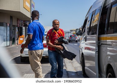 Cape Town, South Africa - January 2021: Black South African Men Getting Out Of Minibus Taxi Wearing Face Masks To Prevent The Corona Virus In Africa.