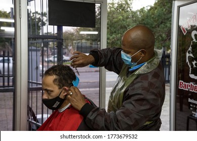 Cape Town, South Africa - July 2020: Front Line Worker,African Barber Wearing Protective Mask Cutting Customers Hair Who Is In Face Mask, Covid 19 Corona Virus In Africa. Lock Down Hair Cut. 