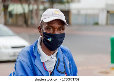 Cape Town, South Africa - May 2020: African Elderly Male/Cleaner Sanitizing Shopping Carts/trolley  Wearing Face Mask During Corona Virus Pandemic In Africa. Poverty, Minimum Wage, Front Line Worker.