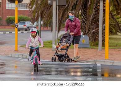 Cape Town, South Africa - May 2020: Adventurous Family Exercising Outdoors In Suburb Wearing Face Mask During Winter, Corona Virus Pandemic In Africa