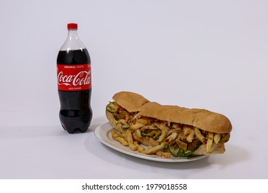 Cape Town, South Africa - May 2021: South African Gatsby. Masala Steak Gatsby With Coca Cola. Traditional Cape Malay Food.