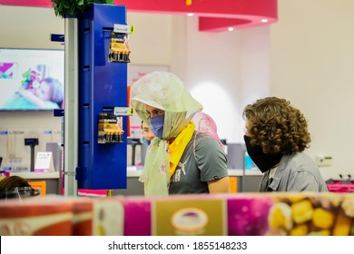 Cape Town, South Africa - November 2020: South African Youth Wearing Funny Face Masks In Retail Store