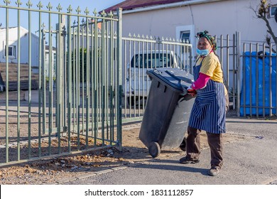 Cape Town, South Africa - October 2020: Black African Female Garbage Collector In Africa During Covid 19 Pandemic Wearing Face Mask For Protection. Front Line Worker, Corona Virus.